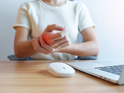 Woman having wrist pain when using mouse during working long time on workplace. De Quervain s tenosynovitis, ergonomic, Carpal Tunnel Syndrome or Office syndrome concept